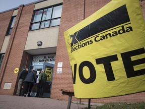 Voters enter the polling station at St. Luigi Catholic School during election day in Toronto on Monday, October 21, 2019. Elections Canada has released some preliminary numbers from Canada's 43rd general election is that help tell the story of the vote, beyond the final results.