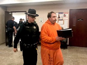 In this Tuesday, Jan. 22, 2019 photo, a law enforcement officer leads William Shrubsall through the Niagara County Court House in Lockport, N.Y. A New York judge has dealt a setback to Shrubsall's bid to reduce his jail time ??? to the relief of a detective who ended the offender's spree of violence against Nova Scotia women.