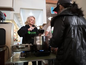 Actress and animal rights activist Pamela Anderson serves free vegan meals during an event held by Green Party candidate for East Vancouver Bridget Burns to register voters for the federal election, in the downtown Eastside of Vancouver, on Wednesday October 9, 2019. Actress Pamela Anderson is asking Prime Minister Justin Trudeau to take meat and milk off prison menus to help the planet and the health of federal inmates, and save taxpayers some cash, to boot.
