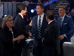 Liberal leader Justin Trudeau shakes hands with Conservative leader Andrew Scheer as People's Party of Canada leader Maxime Bernier, Bloc Quebecois leader Yves-Francois Blanchet and Green Party leader Elizabeth May leave the stage following the Federal leaders debate in Gatineau, Quebec, Canada October 7, 2019.