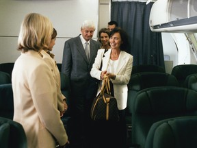 Flight attendants welcome passengers on board the aircraft. Air Canada has announced that they will remove 'ladies and gentlemen' from their introductory greeting in an effort to be more inclusive.
