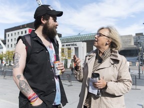 Green Party leader Elizabeth May speaks to a man during a federal election campaign stop in Montreal, Wednesday, October 9, 2019.