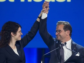 Bloc Quebecois leader Yves-Francois Blanchet has his hand raised by wife Nancy Deziel as he speaks to supporters on federal election night in Montreal, early Tueday morning, October 22, 2019.