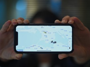 This photo illustration shows a smartphone displaying the "HKmap.live" app in Hong Kong on October 10, 2019. - Apple on October 10 removed an app criticised by China for allowing protesters in Hong Kong to track police, as Beijing steps up pressure on foreign companies deemed to be providing support to the pro-democracy movement.