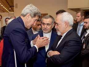 Then-U.S. Secretary of State John Kerry speaks with Hossein Fereydoun, the brother of Iranian President Hassan Rouhani, and Iranian Foreign Minister Javad Zarif, at the Austria Center in Vienna, Austria, on July 14, 2015.
