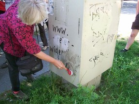 German antifascist activist Irmela Mensah-Schramm, removing neonazi propaganda in Berlin-Frohnau.