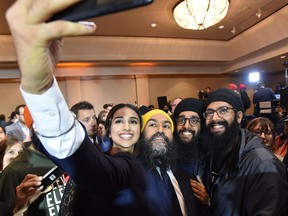 NDP Leader Jagmeet Singh and his wife, Gurkiran Kaur, take a selfie with supporters at an NDP election night party in Burnaby, B.C., on Oct. 21, 2019.