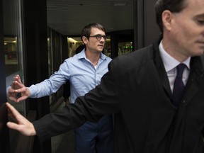 Cameron Ortis, a senior intelligence official at the RCMP, leaves the courthouse in Ottawa with his lawyer Ian Carter, right, after being granted bail, Tuesday, Oct. 22, 2019. Ortis is accused on charges of violating the Security of Information Act and breach of trust for allegedly disclosing secrets to an unknown recipient.