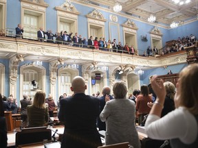 Native leaders join hands while members of the National Assembly applaud after Quebec Premier Francois Legault apologized to First Nations and Inuit leaders during a declaration at the legislature in Quebec City Wednesday, October 2, 2019.