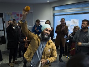 NDP Leader Jagmeet Singh hoists an orange after thanking his staff at his campaign office in Burnaby, B.C., on Monday, Oct. 21, 2019.