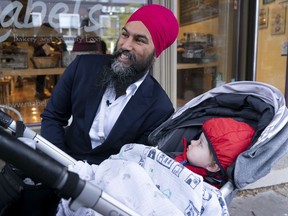 NDP Leader Jagmeet Singh stops to have his picture taken with a baby in a carriage while main streeting in Toronto, on Thursday, October 3, 2019.