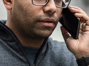 A man uses his cell phone in Toronto.