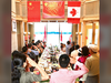 A group salutes in unison the flags of Canada, China and the PLA during a 2018 retreat in Ontario’s cottage country.