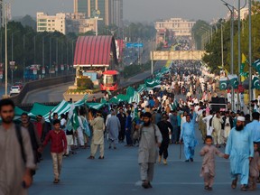 People hold large flag of Pakistan-administered Kashmir at the Kashmir Million March and World Largest Flag demonstration in solidarity with Indian-administered Kashmiris, in Islamabad on October 20, 2019.