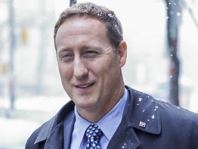 Peter MacKay leaves the Albany Club on King St. East as the snow falls in Toronto on Thursday February 25, 2016.