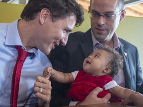 Liberal leader Justin Trudeau greets a young patron while campaigning at a restaurant Friday, October 4, 2019 in Quebec City.THE CANADIAN PRESS/Ryan Remiorz