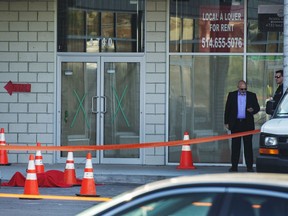 Investigators stand near the body of alleged mob boss Andrew Scoppa, who was shot to death, in Montreal, Monday, Oct. 21, 2019.