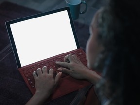 A woman looks at her laptop screen. A new book helps users unhook themselves from the habit of constantly perusing their digital screens.