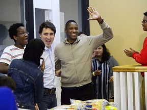 Liberal Leader Justin Trudeau and Toronto Raptors President Masai Ujiri attend a Thanksgiving food drive in Toronto on Sunday, Oct. 13, 2019.