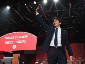Liberal leader Justin Trudeau waves as he celebrates at Liberal election headquarters in Montreal on Monday Oct. 21, 2019.