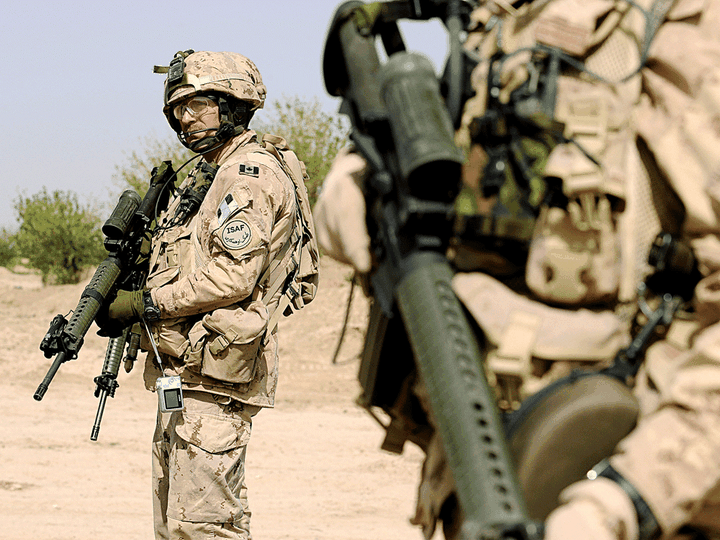  Canadian soldiers stand guard during a patrol in the Panjwayi district of Afghanistan, March 28, 2008.