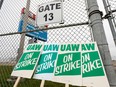 United Auto Workers (UAW) strike signs are shown at a gate at the General Motors Flint Assembly Plant.
