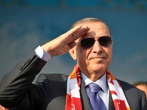 In this handout photo, Turkish President Tayyip Erdogan salutes during a gathering in Kayseri, Turkey, October 19, 2019.