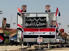 Posters of Syrian President Bashar al-Assad are seen at the Iraqi-Syrian border in Al Qaim, Iraq, on Sept. 30, 2019.