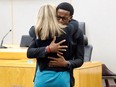 Botham Jean's younger brother Brandt Jean hugs former Dallas police officer Amber Guyger after delivering his impact statement to her following her 10-year prison sentence for murder at the Frank Crowley Courts Building in Dallas, Texas, U.S. Oct. 2, 2019.