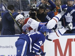 Canadiens' Jonathan Drouin gets taken into the bench in second-period action against the Maple Leafs at the Scotiabank Arena in Toronto on Saturday, Oct. 5, 2019.