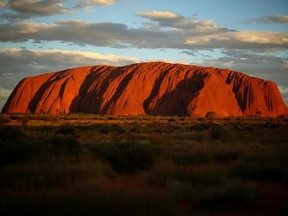 Uluru is seen at as the sun sets on November 27, 2013 in Uluru-Kata Tjuta National Park, Australia.