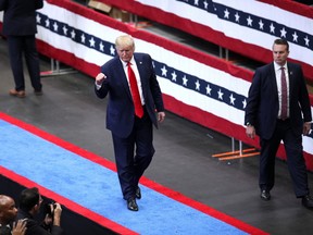 U.S. President Donald Trump pumps his fist as he leaves the stage during a rally in Dallas, Texas, U.S., on Thursday, Oct. 17, 2019. Trump's Doral golf resort in Miami will be the site of next year's Group of Seven summit, a decision that reignited claims he's violating a constitutional prohibition against profiting from the presidency.