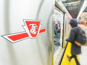 People board a TTC train at the Bloor-Yonge subway platform.