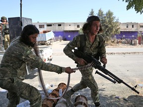Turkish-backed Syrian fighters take part in a battle in Syria's northeastern town of Ras al-Ain along the Turkish border as Turkey and its allies continue their assault on Kurdish-held border towns in northeastern Syria on Oct. 14, 2019.