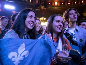 Bloc Quebecois supporters watch election results as they wait at party leader Yves-Francois Blanchet’s election night event in Montreal, on Monday, October 21, 2019.