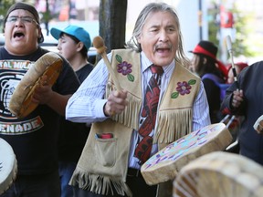 Chief Martin Louie  from the Nordleh Whuten First Nation, located in central BC, joined drummers as they sang traditional songs outside a meeting regarding the Enbridge pipeline on September 11, 2014.