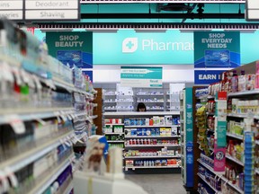 An employee works in the pharmacy at a Rexall Health drugstore location in Toronto, Ontario, Canada, on Wednesday, March 2, 2016.
