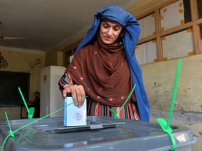 A woman casts her vote for the presidential election at a polling station in Jalalabad, Afghanistan, on Sept. 28, 2019.