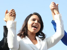 Democratic presidential candidate U.S. Rep. Tulsi Gabbard (D-HI) sings during the inaugural Veterans Day L.A. event held outside of the Los Angeles Memorial Coliseum on November 11, 2019 in Los Angeles, California.