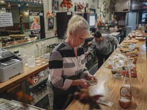 Nancy Davis, owner of Nancy’s Cafe, counts money at the restaurant in Malone, N.Y., Oct. 17, 2019.