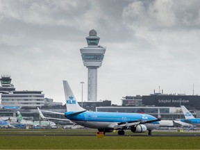 A picture taken on March 2, 2016 shows KLM Royal Dutch Airlines planes close to the control tower at Schiphol Airport in Amsterdam.