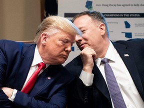 In this file photo taken on October 21, 2019, U.S. President Donald Trump (L) listens to U.S. Secretary of State Mike Pompeo during a Cabinet Meeting at the White House in Washington,D.C.