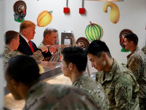 U.S. President Donald Trump serves U.S. troops food at a Thanksgiving dinner event during a surprise visit at Bagram Air Base in Afghanistan, November 28, 2019.