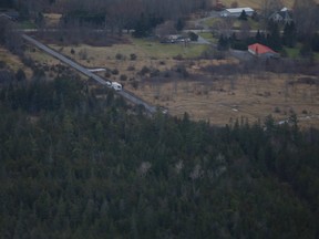 An aerial view of the plane crash scene shows police vehicles along a gravel road leading to a wooded area south of Highway 401 in Kingston, Ont. on Thursday, Nov. 27, 2019.  Elliot Ferguson/The Whig-Standard/Postmedia Network