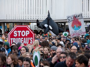An inflatable orca is pictured next to a stop sign protesting the Canadian federal government's purchase of an oil pipeline project, during a climate strike rally in Vancouver, British Columbia, Canada October 25, 2019.