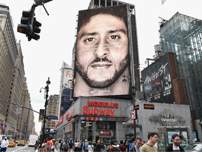 In this file photo taken on September 08, 2018 a Nike Ad featuring American football quarterback  Colin Kaepernick is on diplay in New York City.