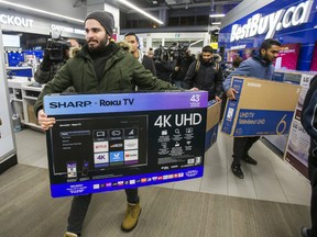 Black Friday shoppers snap up televisions upon entering Best Buy along Dundas St. W. and Bay St., as they opened at around 6am in Toronto, Ont. on Friday November 23, 2018.