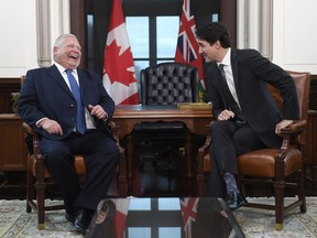 Prime Minister Justin Trudeau and the Premier of Ontario Doug Ford share a laugh after Ford spoke in French during a meeting in Ottawa on Friday, Nov. 22, 2019.