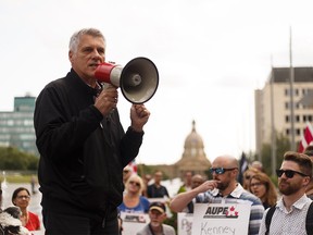 Alberta Union of Provincial Employees (AUPE) president Guy Smith speaks to members and supporters as they march from Capital Plaza near the Alberta Legislature to Jasper Ave while protesting Bill 9 in Edmonton, on Wednesday, July 31, 2019.