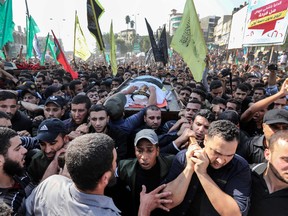 Mourners chant slogans as they carry the body of Palestinian Islamic Jihad senior leader Baha Abu Al-Ata during his funeral in Gaza City on November 12, 2019.